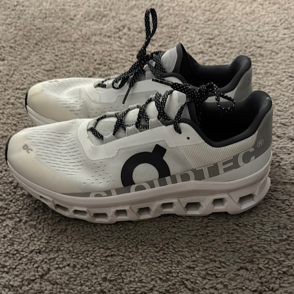 On Running White and Black Athletic Shoes with Cloud Cushioning